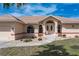 Charming home showcasing a tiled roof, double front doors, and manicured landscaping at 5720 Almar Dr, Punta Gorda, FL 33950