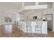 Modern kitchen featuring a breakfast bar, sleek appliances, and plenty of storage space at 5720 Almar Dr, Punta Gorda, FL 33950