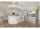 Modern kitchen with sleek appliances, breakfast bar, and sliding doors to the patio at 5720 Almar Dr, Punta Gorda, FL 33950