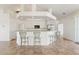 Kitchen featuring white cabinets, stainless steel appliances, and a kitchen bar with seating at 5720 Almar Dr, Punta Gorda, FL 33950