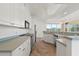 Kitchen featuring modern appliances, white cabinetry, and a breakfast bar, perfect for entertaining at 5720 Almar Dr, Punta Gorda, FL 33950