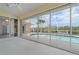 Covered lanai overlooking the pool, backyard, and canal, perfect for outdoor entertaining at 5720 Almar Dr, Punta Gorda, FL 33950