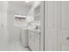 Well-lit laundry room with washer, dryer, sink, and white cabinets, offering functionality and storage at 5720 Almar Dr, Punta Gorda, FL 33950