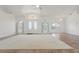 Spacious living room featuring high ceilings, decorative windows, and tile flooring at 5720 Almar Dr, Punta Gorda, FL 33950