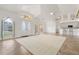 Open-concept living room with vaulted ceilings, large windows, and adjacent kitchen at 5720 Almar Dr, Punta Gorda, FL 33950
