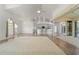 Open-concept living room showcasing tile floors, white walls, and a kitchen bar with seating at 5720 Almar Dr, Punta Gorda, FL 33950