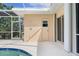 Covered pool area with views of the house, featuring a shower, door, and screened enclosure at 5720 Almar Dr, Punta Gorda, FL 33950