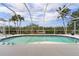 Beautiful, screened pool with a gorgeous waterfront view surrounded by palm trees at 5720 Almar Dr, Punta Gorda, FL 33950