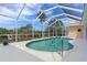 Relaxing screened-in pool area overlooking a scenic canal view, ideal for outdoor enjoyment at 5720 Almar Dr, Punta Gorda, FL 33950