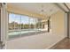 Bright sunroom with tile floor, ceiling fan, and sliding glass doors open to pool and lush backyard at 5720 Almar Dr, Punta Gorda, FL 33950