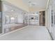 Bright sunroom with tile floor, ceiling fan, and sliding glass doors lead to spacious living area at 5720 Almar Dr, Punta Gorda, FL 33950