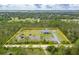 Stunning aerial view of the property, showcasing the home, surrounding land, and lush greenery at 6405 Alan Blvd, Punta Gorda, FL 33982