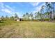 This property features a shed, surrounded by a sprawling backyard and a lush treeline at 6405 Alan Blvd, Punta Gorda, FL 33982