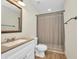 Well-lit bathroom with modern vanity, toilet, shower and neutral color scheme at 6405 Alan Blvd, Punta Gorda, FL 33982