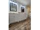 Bathroom featuring double sinks, modern cabinets, and wood floors at 6405 Alan Blvd, Punta Gorda, FL 33982