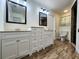 Bright bathroom featuring double vanities, wood-look flooring, and a separate water closet at 6405 Alan Blvd, Punta Gorda, FL 33982