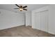 Minimalist bedroom with ceiling fan, closet, and neutral carpet at 6405 Alan Blvd, Punta Gorda, FL 33982