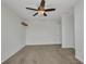 Cozy bedroom with carpet flooring, neutral paint, closet and overhead ceiling fan at 6405 Alan Blvd, Punta Gorda, FL 33982