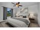 Comfortable bedroom features neutral tones, a ceiling fan, and an inviting atmosphere with a view to nature at 6405 Alan Blvd, Punta Gorda, FL 33982