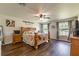 Bright bedroom featuring a wooden bed frame, farmhouse decor, and wood floors at 6405 Alan Blvd, Punta Gorda, FL 33982