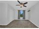 Bright bedroom with a ceiling fan, window, and closet, offering a comfortable living space at 6405 Alan Blvd, Punta Gorda, FL 33982