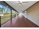 Spacious covered deck with wood floors and ceiling fans overlooking private backyard at 6405 Alan Blvd, Punta Gorda, FL 33982