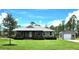 Beautiful single-story home with a covered porch, lush lawn, and a detached garage or shed on a sunny day at 6405 Alan Blvd, Punta Gorda, FL 33982