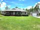 Charming single-story home with covered porch and detached garage on a sprawling lawn at 6405 Alan Blvd, Punta Gorda, FL 33982