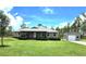 Inviting single-story home with a well-manicured lawn and a detached garage or shed on a sunny day at 6405 Alan Blvd, Punta Gorda, FL 33982