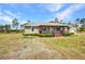 Exterior shot of home with a covered porch and well-maintained yard at 6405 Alan Blvd, Punta Gorda, FL 33982