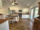 Well-lit kitchen with stainless appliances, white cabinets, and butcher block counters and kitchen island at 6405 Alan Blvd, Punta Gorda, FL 33982