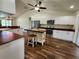 A spacious kitchen with white cabinetry, stainless steel appliances, and a rustic kitchen island at 6405 Alan Blvd, Punta Gorda, FL 33982