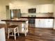 Well-lit kitchen boasts stainless appliances, white cabinets, butcher block counters, and island with stool at 6405 Alan Blvd, Punta Gorda, FL 33982