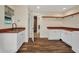Well lit laundry area features white cabinets, wood counters, and open shelving at 6405 Alan Blvd, Punta Gorda, FL 33982