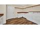 Laundry room with white cabinets, wood counters, open wood shelving and a washer and dryer at 6405 Alan Blvd, Punta Gorda, FL 33982