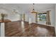 Open-concept living space with wood floors, windows, and a ceiling fan at 6405 Alan Blvd, Punta Gorda, FL 33982