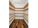 Walk-in pantry with wooden shelves and wood look flooring at 6405 Alan Blvd, Punta Gorda, FL 33982