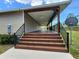 View of the back porch featuring wood stairs and railings at 6405 Alan Blvd, Punta Gorda, FL 33982