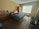 A simple bedroom with natural light from the window at 8782 La Boca Ave, North Port, FL 34287