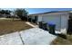 One-story home with an attached garage, solar panels and recycling bins at 8782 La Boca Ave, North Port, FL 34287