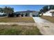 This home has solar panels, an attached garage and a grassy front yard at 8782 La Boca Ave, North Port, FL 34287