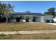 Single-story home featuring solar panels on the roof and a well-maintained front yard at 8782 La Boca Ave, North Port, FL 34287