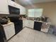 Kitchen featuring white cabinets, an electric range, a microwave, and a dishwasher at 8782 La Boca Ave, North Port, FL 34287