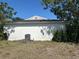 Exterior shot of a home with an AC unit and partial view of backyard at 8782 La Boca Ave, North Port, FL 34287