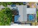 Overhead view showing the roof, backyard, and the screened in pool enclosure at 8795 56Th N St, Pinellas Park, FL 33782