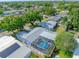 A high angle shot of the backyard pool enclosure and surrounding properties at 8795 56Th N St, Pinellas Park, FL 33782