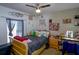 Comfortable bedroom with a ceiling fan, a window with dark curtains and a full sized bed at 8795 56Th N St, Pinellas Park, FL 33782