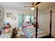 Well-lit bedroom features a ceiling fan, and a comfortable bed with a light blue curtain at 8795 56Th N St, Pinellas Park, FL 33782