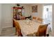 Dining area with table for six and a cabinet with books and glassware at 8795 56Th N St, Pinellas Park, FL 33782