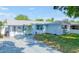 Charming single-story home with a light-blue painted exterior, neat landscaping, and a gray paved driveway at 8795 56Th N St, Pinellas Park, FL 33782